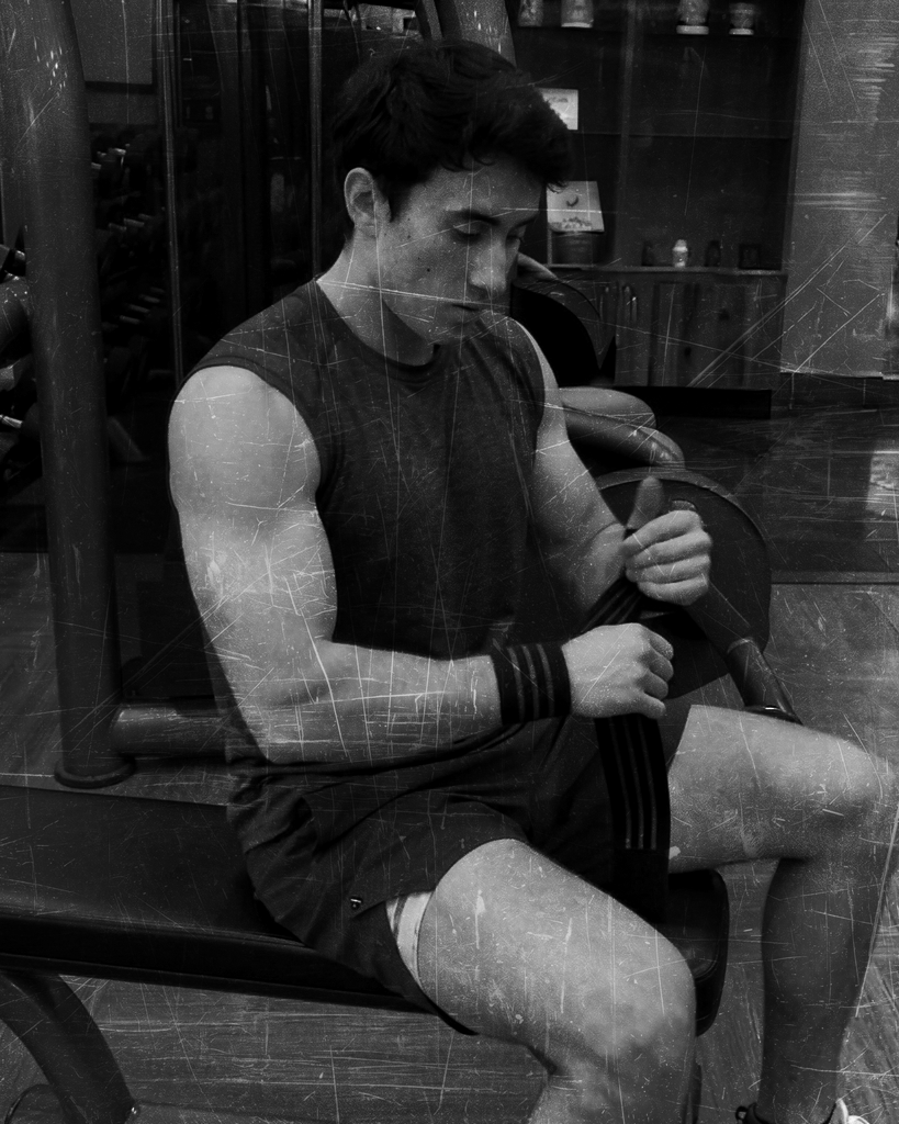Matthew Hasychak wrapping his wrists on a bench in the gym